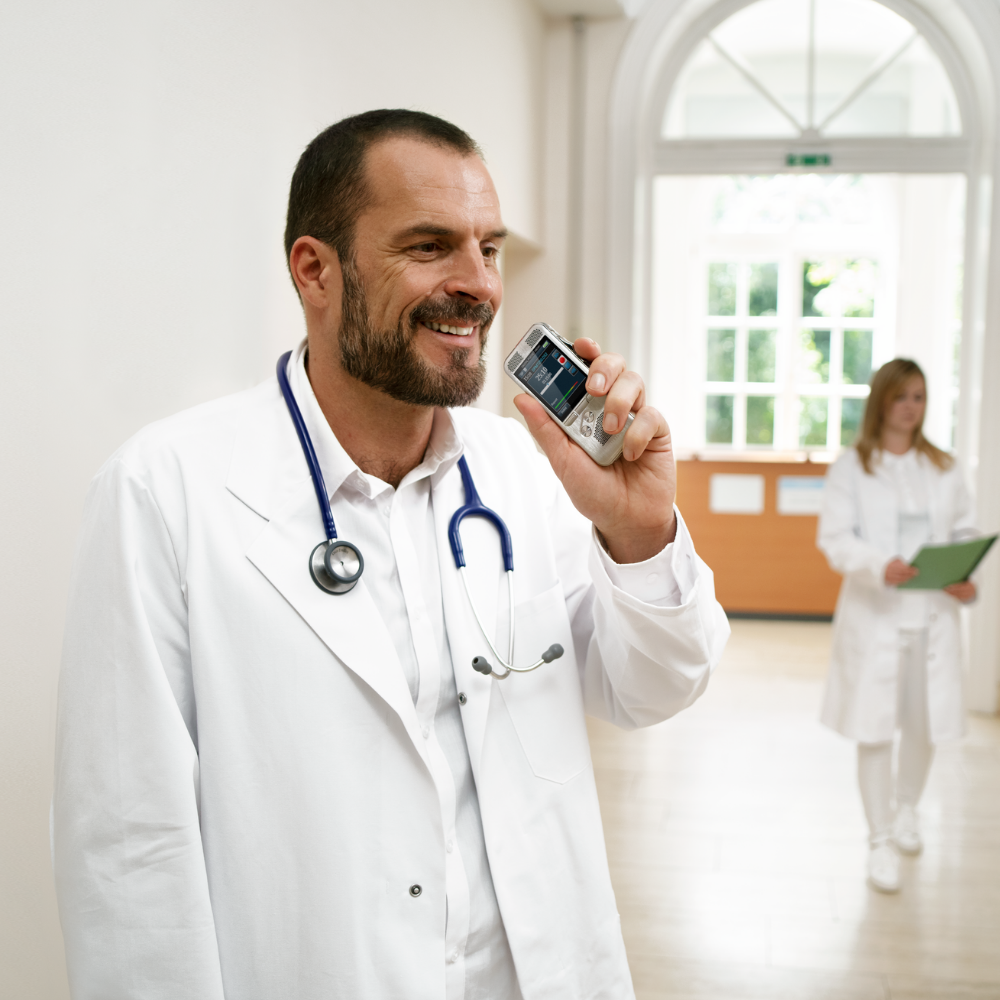 Doctor using a professional dictation recorder with SpeechLive and Dragon Medical One